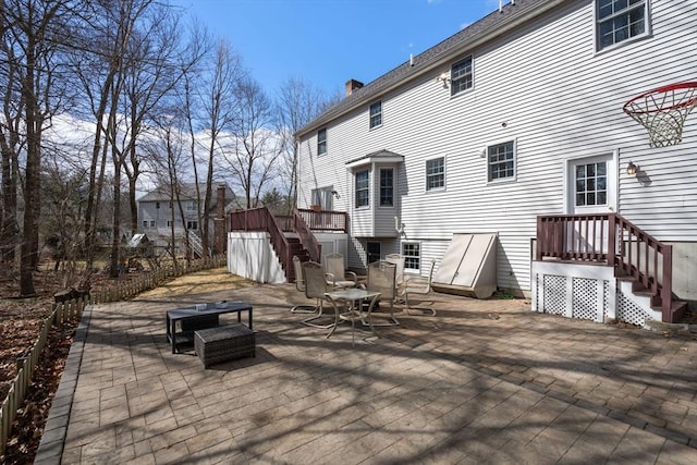 exterior space featuring a patio area, stairway, and outdoor dining area