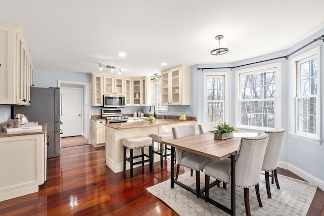 dining area with dark wood finished floors and baseboards