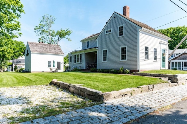 rear view of house with a yard