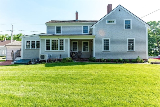 back of house featuring a lawn and ac unit