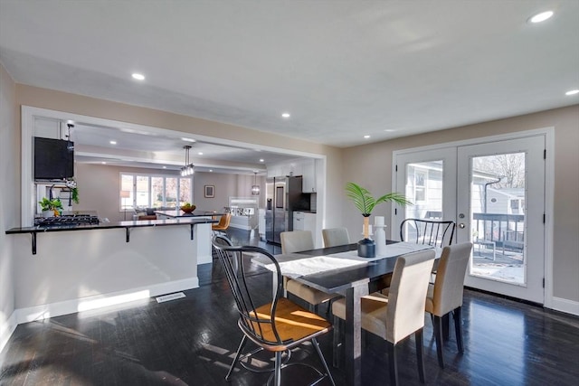 dining area featuring french doors and dark hardwood / wood-style flooring