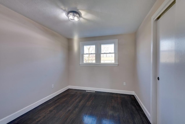 unfurnished room with dark hardwood / wood-style floors