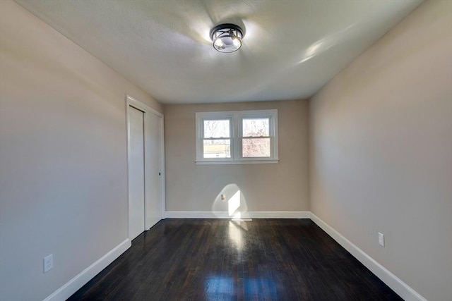 spare room with dark hardwood / wood-style floors