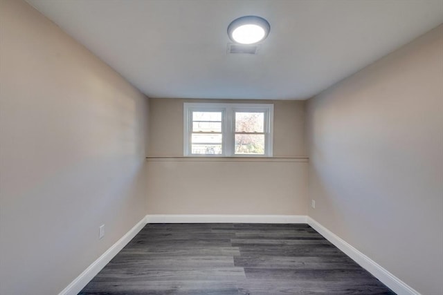 spare room with dark hardwood / wood-style flooring