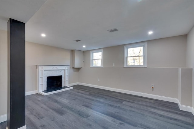 unfurnished living room featuring a fireplace and dark hardwood / wood-style floors