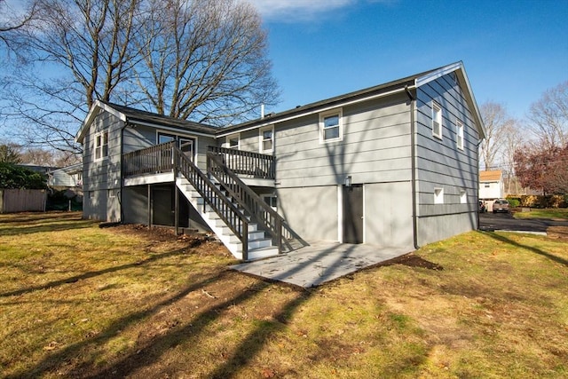 rear view of property with a lawn and a deck