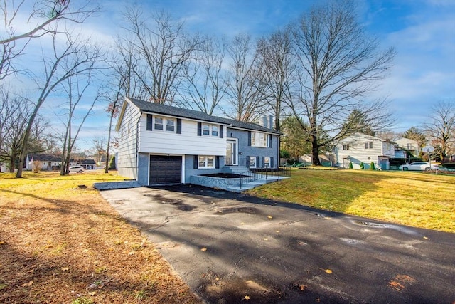 raised ranch with a front yard and a garage