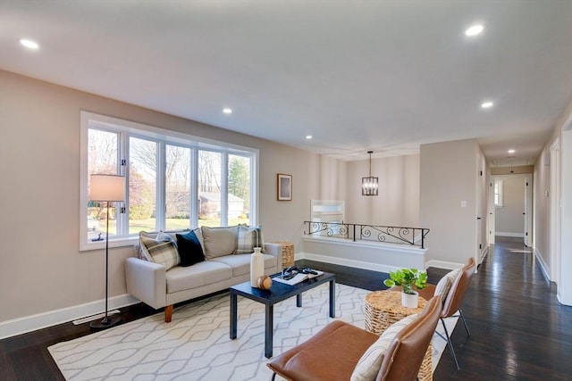 living room featuring hardwood / wood-style floors and an inviting chandelier