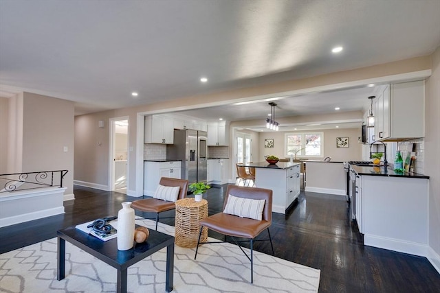 living room with dark hardwood / wood-style flooring and sink