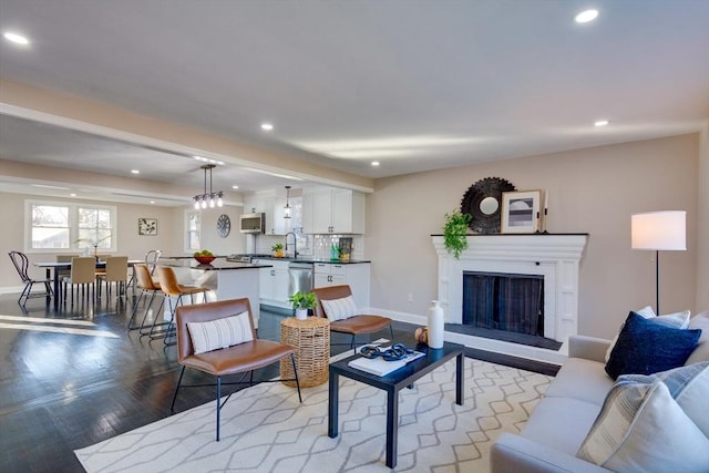 living room featuring light wood-type flooring and sink