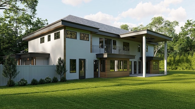 back of property with a yard, a balcony, and a patio