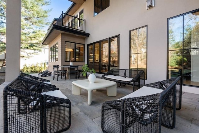 view of patio / terrace featuring outdoor dining space and a balcony