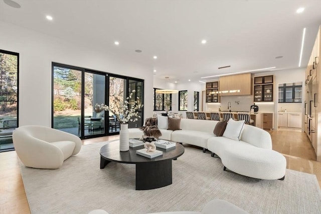 living area featuring light wood finished floors and recessed lighting