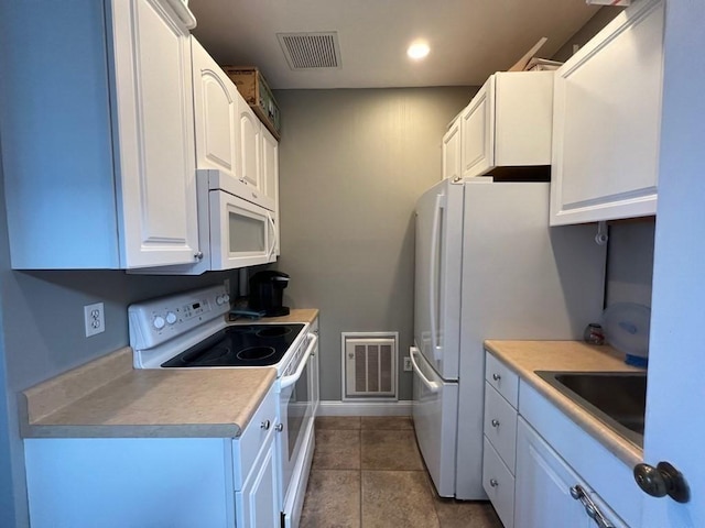 77 Adams St Unit 109, Quincy, MA 02169 - kitchen with white appliances, a sink, white cabinetry, baseboards, and recessed lighting