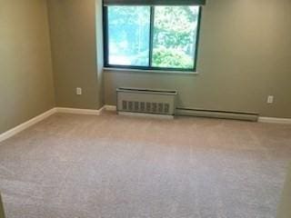 77 Adams St Unit 109, Quincy, MA 02169 - carpeted empty room featuring plenty of natural light, baseboards, and baseboard heating