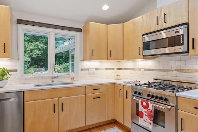5 Mason St, Lexington, MA 02421 - kitchen featuring appliances with stainless steel finishes, light brown cabinets, light countertops, tasteful backsplash, and recessed lighting