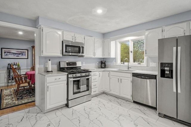 1 Island Rd, Medway, MA 02053 - kitchen with appliances with stainless steel finishes, a sink, light marble finish flooring, light countertops, and recessed lighting
