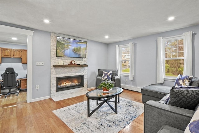 1 Island Rd, Medway, MA 02053 - living area with a stone fireplace, light wood-type flooring, baseboards, recessed lighting, and an office area