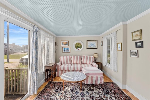 sitting room featuring crown molding and light hardwood / wood-style floors