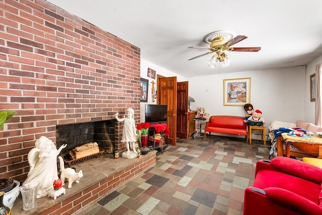 living area with a brick fireplace and a ceiling fan