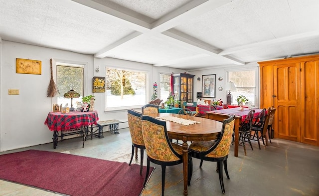 dining area with beam ceiling, coffered ceiling, concrete floors, and a textured ceiling