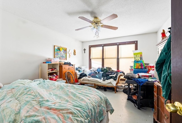 bedroom with a ceiling fan, concrete flooring, and a textured ceiling