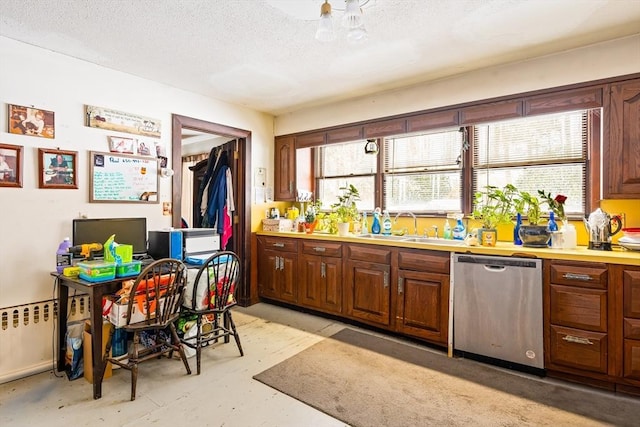 kitchen with dishwasher, a textured ceiling, a sink, and a wealth of natural light