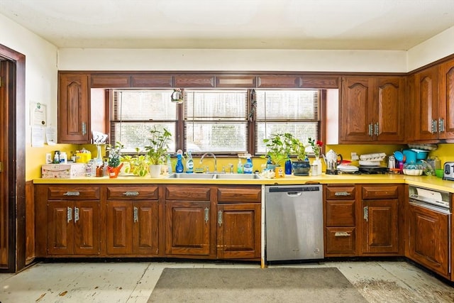 kitchen featuring light countertops, stainless steel dishwasher, a sink, and a healthy amount of sunlight