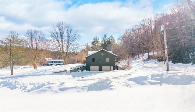 yard covered in snow featuring an outdoor structure