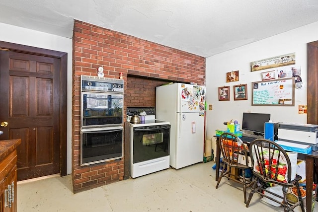 kitchen featuring white appliances and concrete flooring