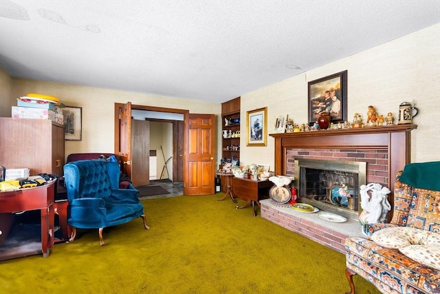 living room featuring carpet, a brick fireplace, and a textured ceiling