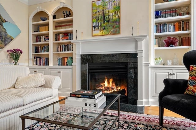 151 Beacon St Unit 4, Boston, MA 02116 - living area with a fireplace, built in features, crown molding, and wood finished floors