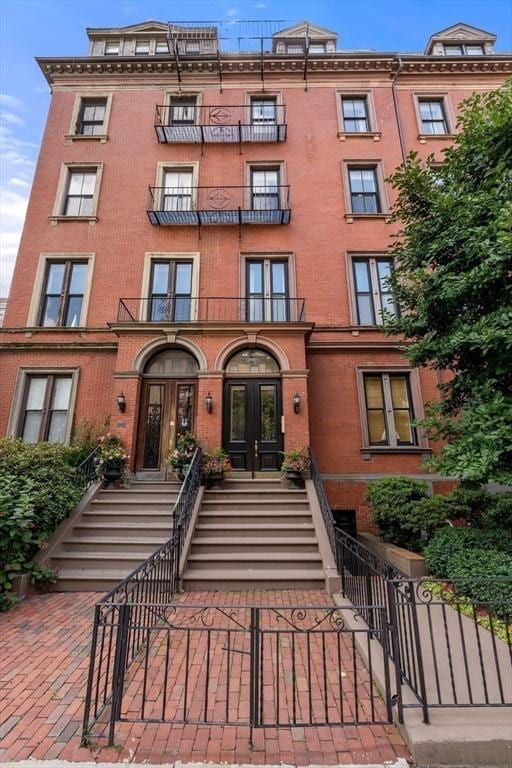 151 Beacon St Unit 4, Boston, MA 02116 - view of apartment building / complex featuring stairs and a fenced front yard