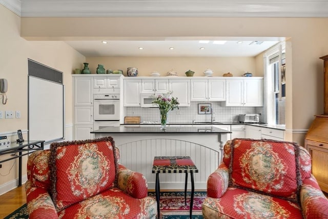 151 Beacon St Unit 4, Boston, MA 02116 - kitchen featuring dark countertops, white cabinets, a sink, white appliances, and tasteful backsplash