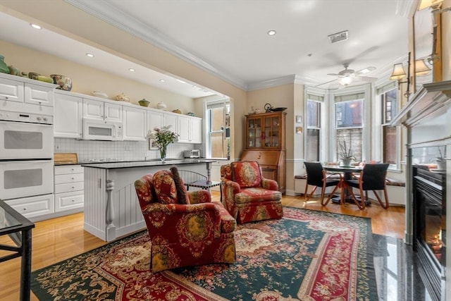 151 Beacon St Unit 4, Boston, MA 02116 - living room with crown molding, plenty of natural light, ceiling fan, recessed lighting, and light wood-style floors