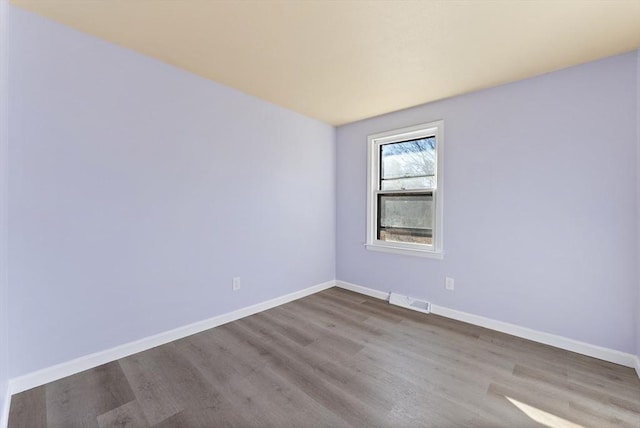 empty room with light hardwood / wood-style floors