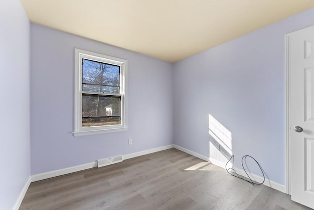 unfurnished room with light wood-type flooring