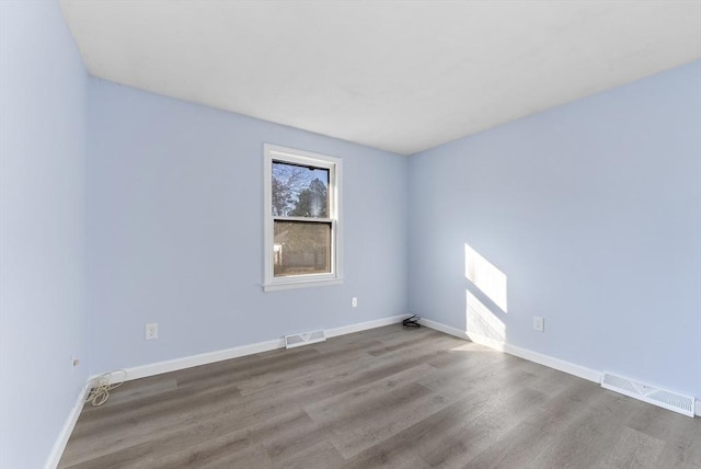 spare room with wood-type flooring