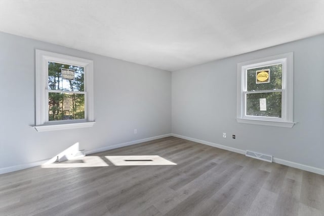 empty room with light hardwood / wood-style flooring