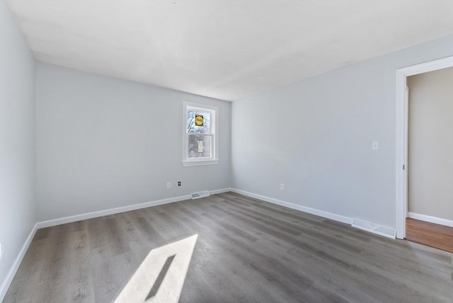 empty room with wood-type flooring