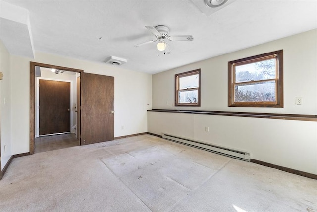 carpeted empty room with baseboard heating and ceiling fan