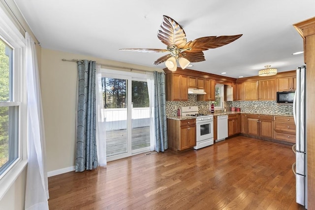 kitchen with white appliances, tasteful backsplash, ceiling fan, and dark wood-type flooring