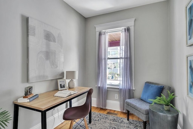 home office featuring baseboards, visible vents, and light wood-style floors