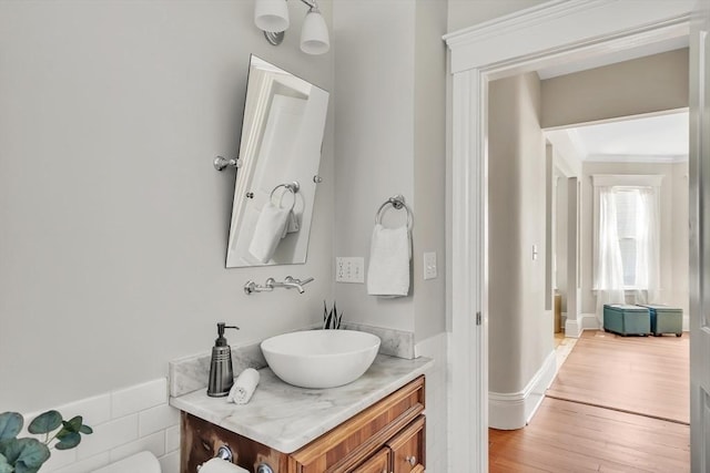 bathroom featuring crown molding, vanity, and wood finished floors