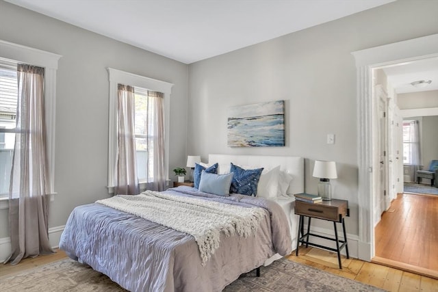 bedroom featuring baseboards and wood-type flooring
