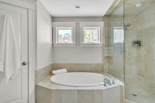 bathroom featuring a garden tub and a stall shower