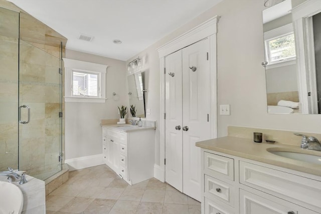 full bathroom with a shower stall, visible vents, a wealth of natural light, and a sink