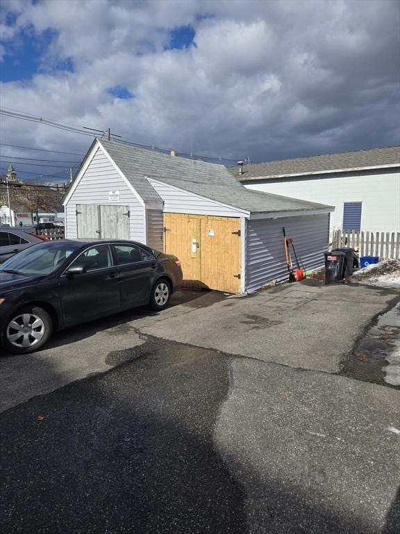 view of vehicle parking with fence