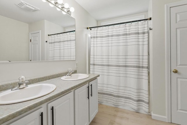 459 Brook St Unit C, Clinton, MA 01510 - bathroom featuring double vanity, wood finished floors, and a shower with curtain