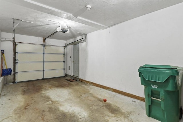 459 Brook St Unit C, Clinton, MA 01510 - garage featuring baseboards and a garage door opener